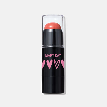 Limited-edition Mary Kay Blush Stick in Kind Spirit shade, featuring a coral cream blush in a sleek black tube with clear cap and pink heart designs.