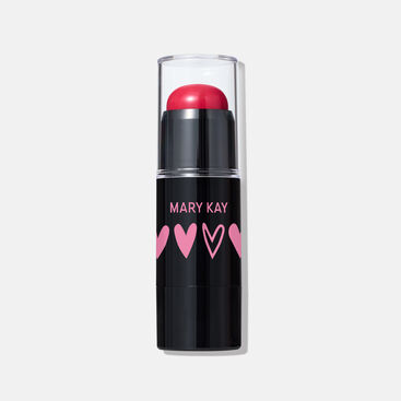Limited-edition Mary Kay Blush Stick in Spark Change shade, featuring a red cream blush in a sleek black tube with pink heart designs and a clear cap.